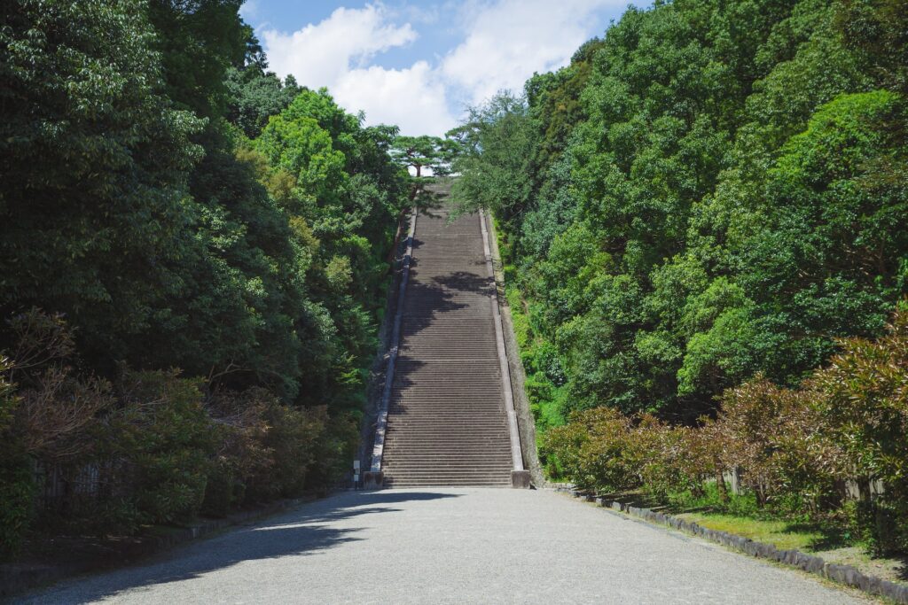 A picture of a stairway in a garden with text over it stating: The Law of Assumption posits that your beliefs and assumptions play a pivotal role in shaping your reality, influencing your experiences and outcomes.